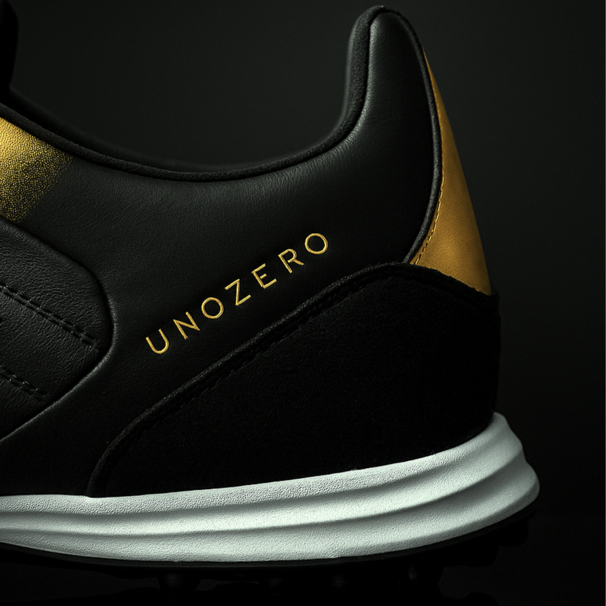 Black and gold sneaker with 'UNOZERO' branding on a black background